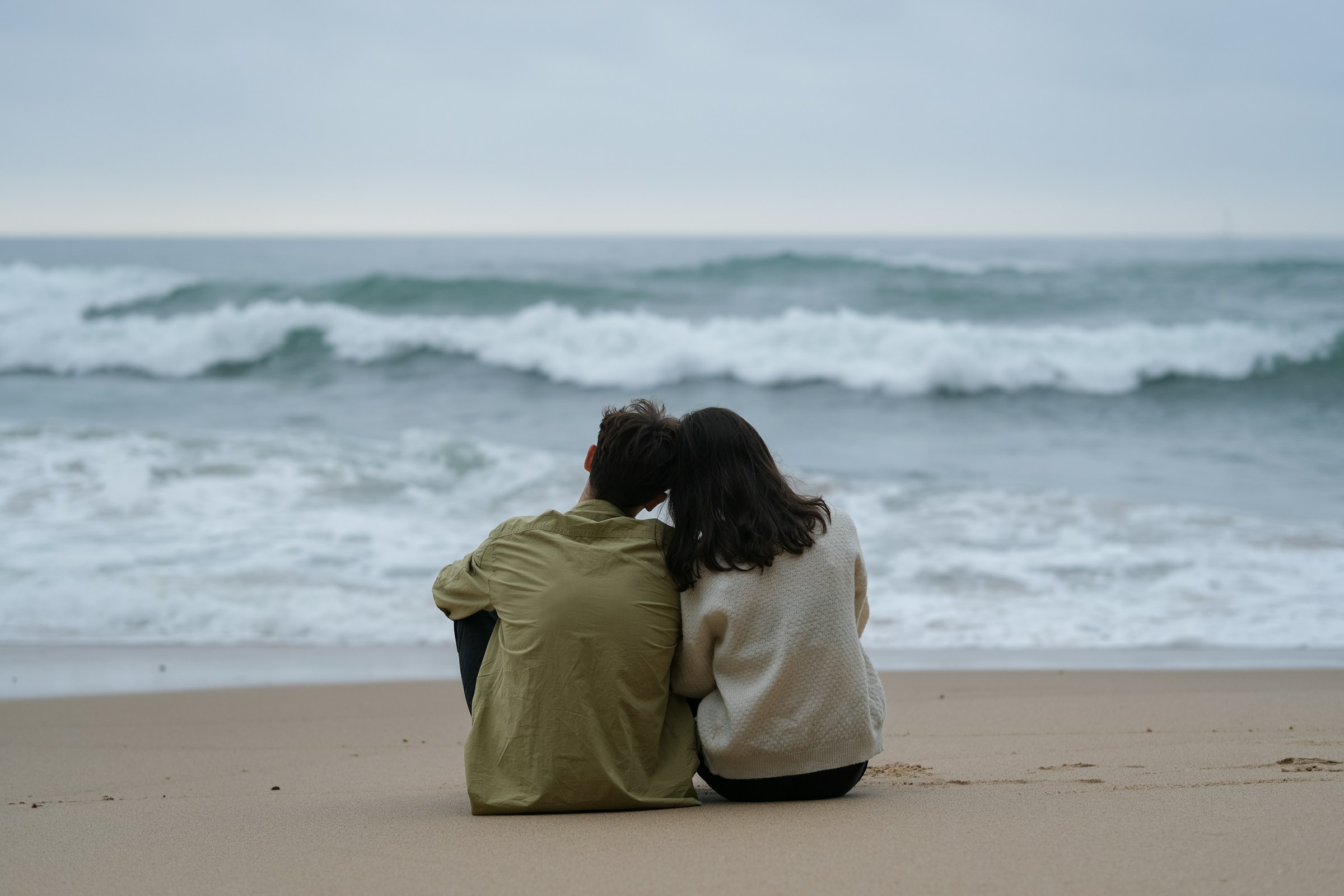 Couple on beach looking at ocean